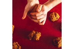 Image Man cooking vegan meat in breadcrumbs.